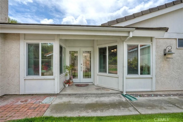 7553 Agua Dulce Ct, Carlsbad, CA 92009 - property entrance with french doors and stucco siding