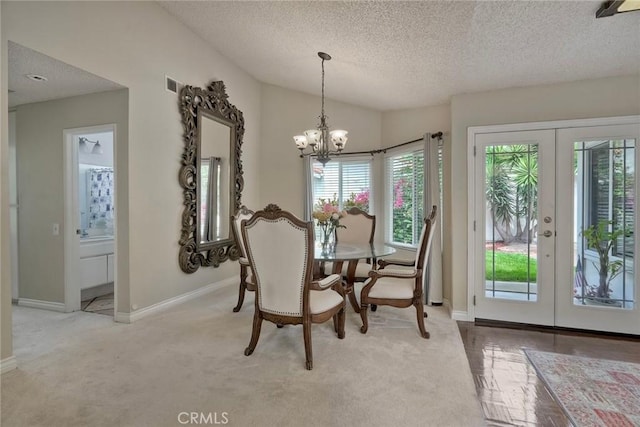 7553 Agua Dulce Ct, Carlsbad, CA 92009 - carpeted dining space with french doors, a textured ceiling, a chandelier, and lofted ceiling