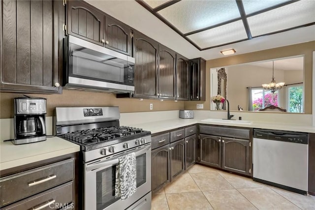 7553 Agua Dulce Ct, Carlsbad, CA 92009 - kitchen with stainless steel appliances, a chandelier, and dark brown cabinets
