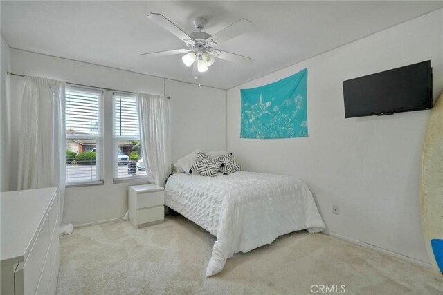bedroom with carpet floors, baseboards, and ceiling fan