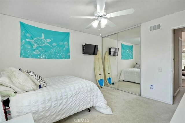 bedroom with ceiling fan, carpet, a closet, and visible vents