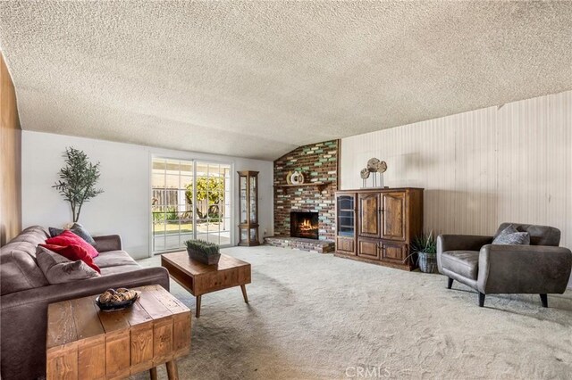 carpeted living room with a textured ceiling, vaulted ceiling, and a fireplace