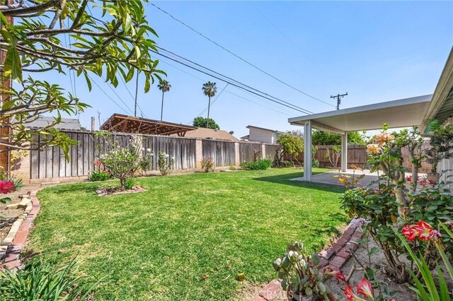 view of yard with a fenced backyard and a patio area