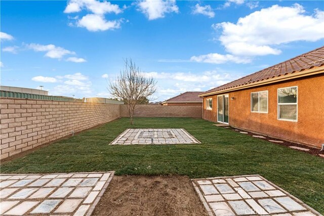 view of yard with a fenced backyard and a patio area