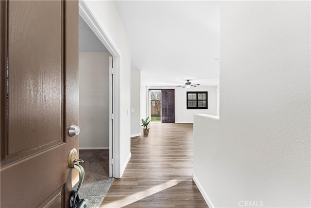 entryway with baseboards, ceiling fan, and wood finished floors