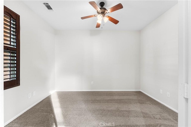 unfurnished room featuring baseboards, a ceiling fan, and visible vents