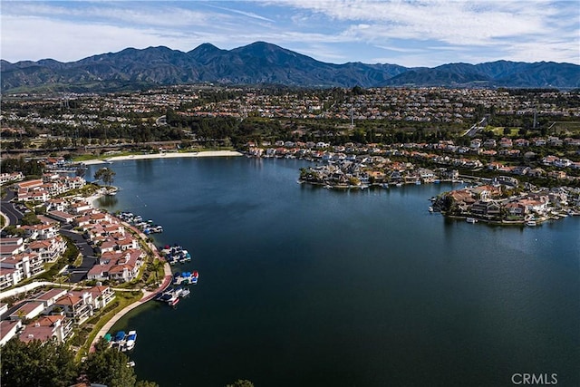 aerial view featuring a water and mountain view and a residential view
