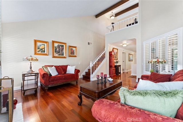 living room featuring beam ceiling, wood finished floors, high vaulted ceiling, baseboards, and stairs