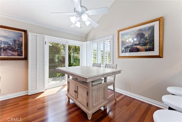 dining area featuring baseboards, ceiling fan, wood finished floors, and vaulted ceiling