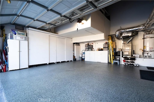 garage featuring strapped water heater and heating unit