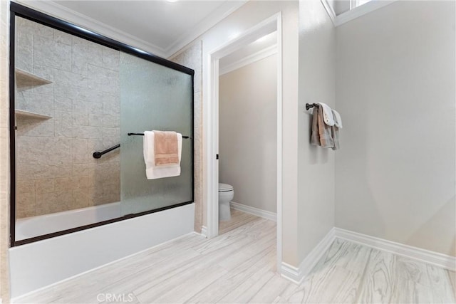 full bathroom with toilet, baseboards, ornamental molding, and combined bath / shower with glass door