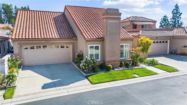 view of front of house with a garage, stucco siding, driveway, and a tile roof