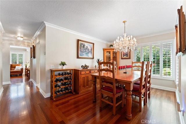 dining space featuring baseboards, ornamental molding, dark wood-style floors, and a chandelier