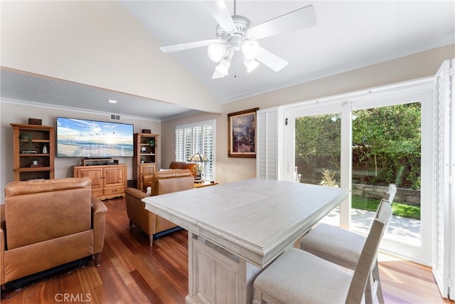 dining area with ornamental molding, ceiling fan, wood finished floors, and vaulted ceiling