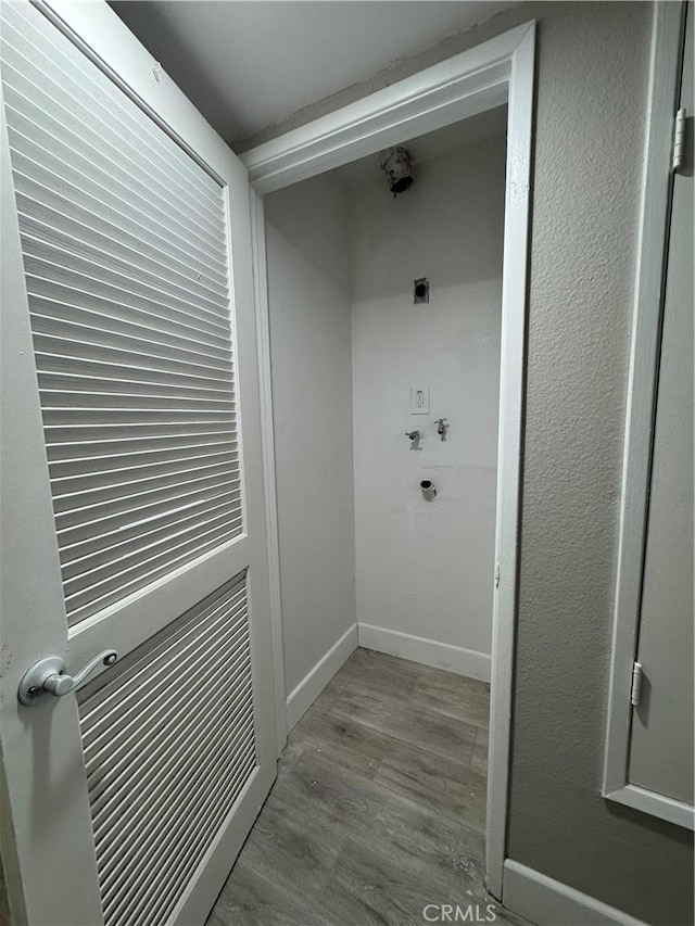 laundry area featuring washer hookup, laundry area, baseboards, wood finished floors, and hookup for an electric dryer