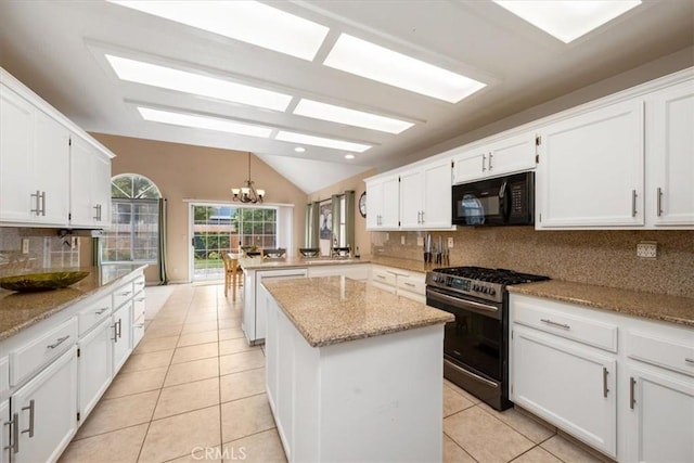 315 Alder St, Arroyo Grande, CA 93420 - kitchen with a peninsula, lofted ceiling, light tile patterned flooring, black microwave, and stainless steel gas range