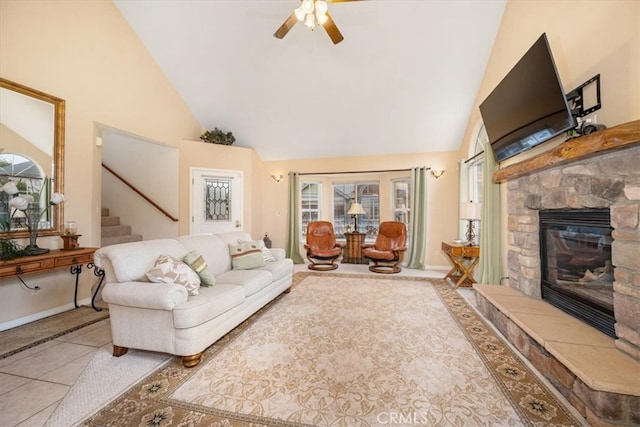 315 Alder St, Arroyo Grande, CA 93420 - tiled living room featuring a stone fireplace, a ceiling fan, plenty of natural light, and high vaulted ceiling