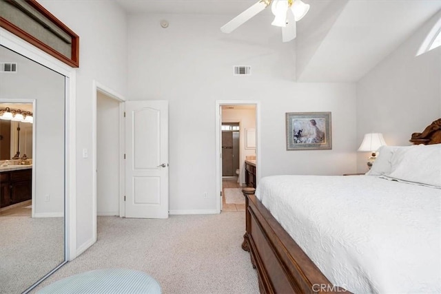 315 Alder St, Arroyo Grande, CA 93420 - bedroom with high vaulted ceiling, visible vents, ensuite bath, and light colored carpet