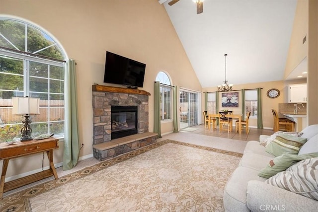 315 Alder St, Arroyo Grande, CA 93420 - living area featuring high vaulted ceiling, baseboards, ceiling fan with notable chandelier, and a stone fireplace