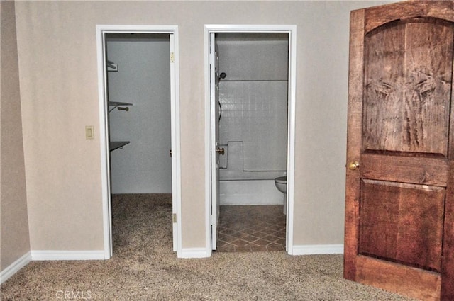 bathroom featuring toilet and baseboards