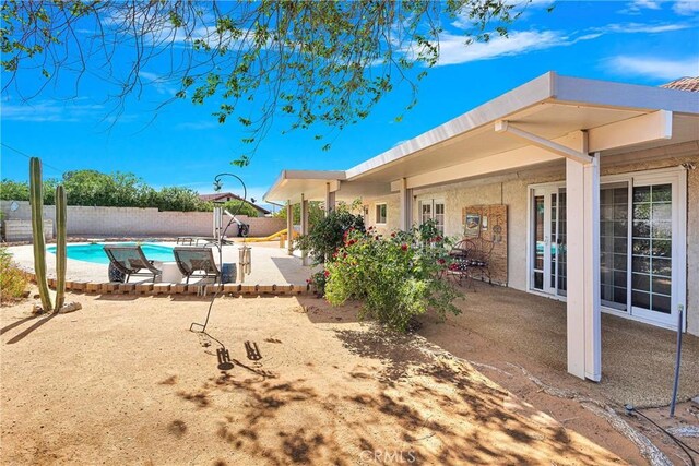 view of pool with a fenced backyard, a fenced in pool, and a patio area