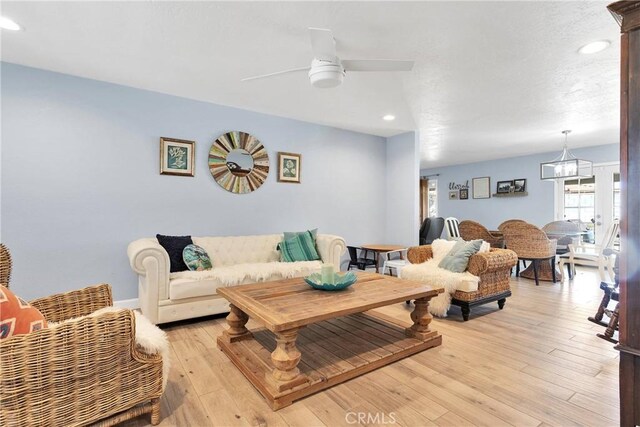 living area with recessed lighting, light wood-style flooring, and ceiling fan