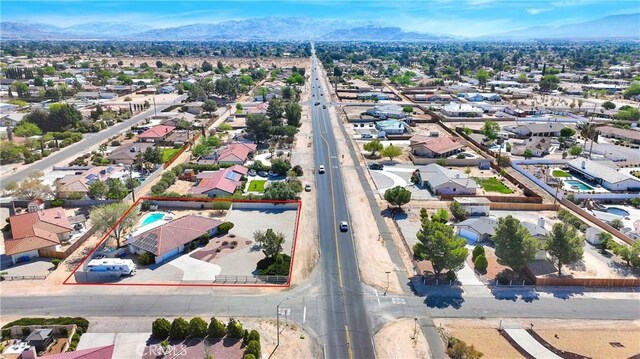 drone / aerial view featuring a residential view and a mountain view