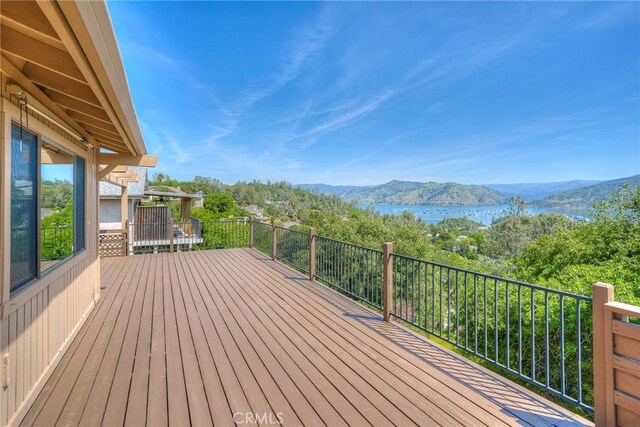 wooden deck featuring a water and mountain view
