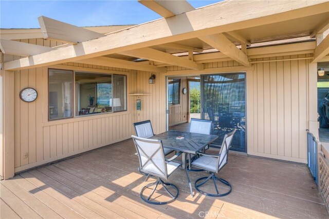 wooden terrace featuring outdoor dining space