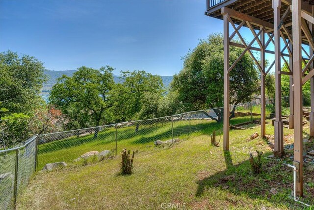view of yard featuring a fenced backyard and a mountain view