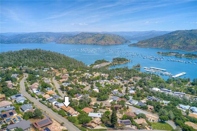 drone / aerial view featuring a water and mountain view