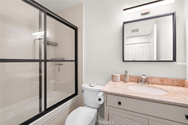 full bath featuring visible vents, combined bath / shower with glass door, toilet, and vanity