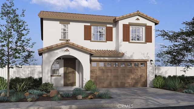 mediterranean / spanish home with a garage, stucco siding, a tiled roof, and concrete driveway
