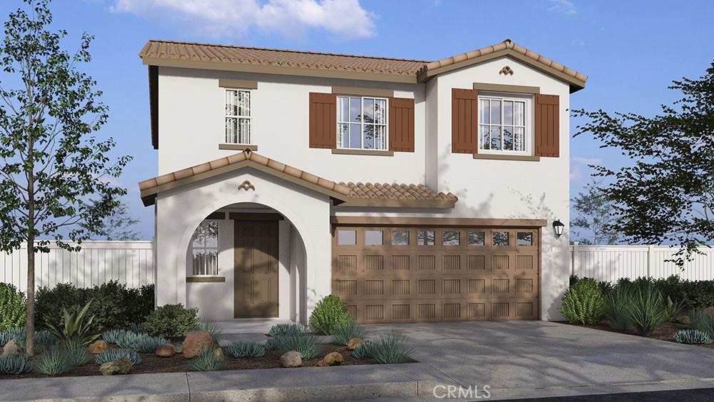 mediterranean / spanish home with a garage, stucco siding, a tiled roof, and concrete driveway