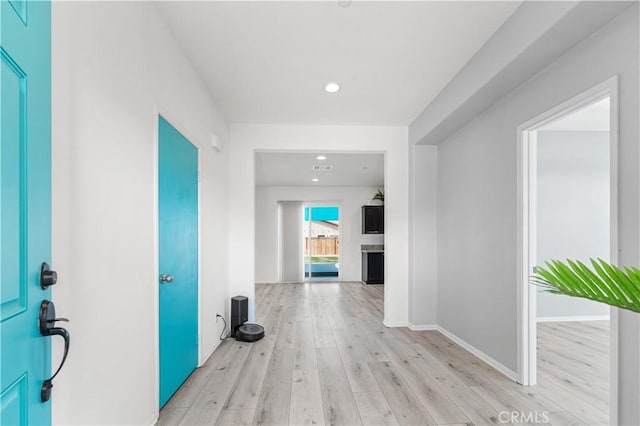 corridor with baseboards, recessed lighting, light wood-style flooring, and visible vents