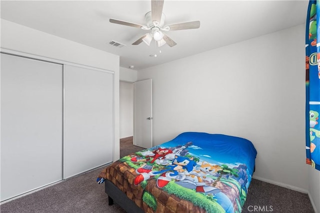 bedroom with visible vents, carpet flooring, a ceiling fan, and a closet