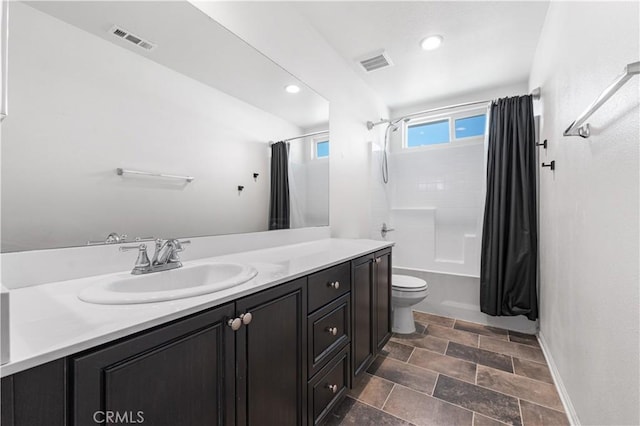 bathroom with toilet, visible vents, shower / tub combo, and vanity