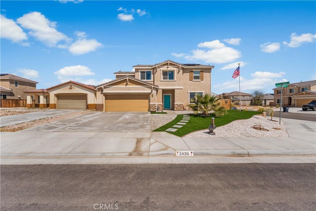 2436 Lugar Bonito Ct, Rosamond, CA 93560 - craftsman inspired home with a front yard, roof mounted solar panels, concrete driveway, an attached garage, and stucco siding