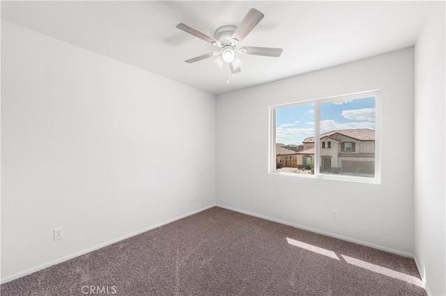 empty room with baseboards, carpet flooring, and ceiling fan