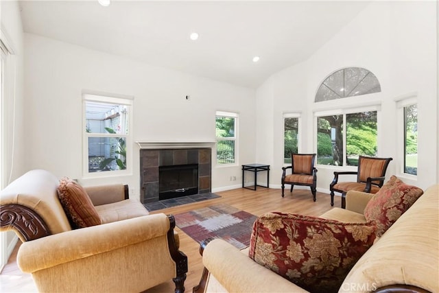 104 Calle Renata, San Dimas, CA 91773 - living area with wood finished floors, recessed lighting, a tiled fireplace, baseboards, and high vaulted ceiling