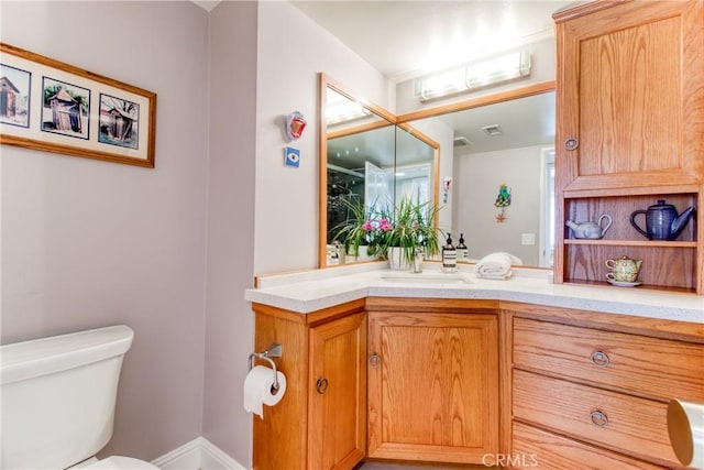 half bath featuring toilet, visible vents, and vanity