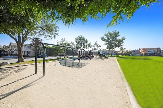 surrounding community with a lawn, a residential view, and playground community
