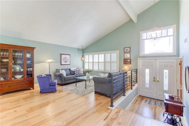 entrance foyer featuring high vaulted ceiling, an inviting chandelier, wood finished floors, and beam ceiling