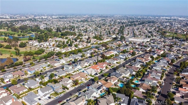 drone / aerial view featuring a water view and a residential view