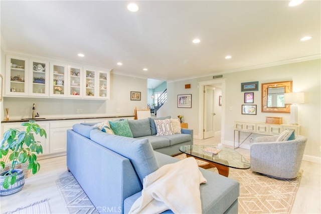 living room featuring recessed lighting, visible vents, and ornamental molding