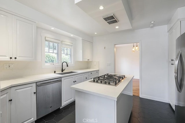 3325 Alana Dr, Sherman Oaks, CA 91403 - kitchen with dark tile patterned floors, stainless steel appliances, white cabinetry, and a sink