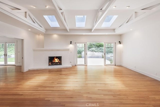 3325 Alana Dr, Sherman Oaks, CA 91403 - unfurnished living room with a skylight, a brick fireplace, high vaulted ceiling, baseboards, and beamed ceiling