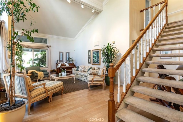22435 Silver Spur, Lake Forest, CA 92630 - living area with crown molding, wood finished floors, stairway, track lighting, and high vaulted ceiling