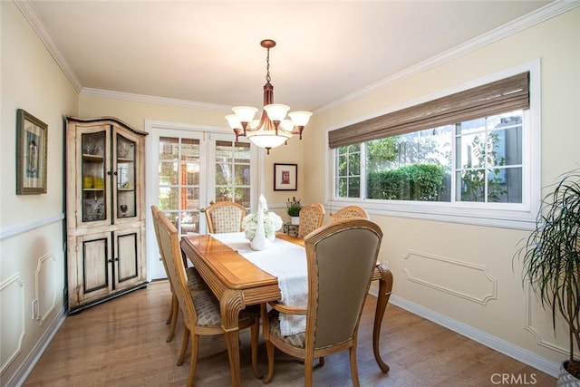22435 Silver Spur, Lake Forest, CA 92630 - dining area with crown molding, baseboards, a notable chandelier, and light wood-type flooring
