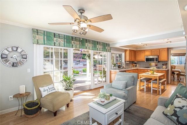 22435 Silver Spur, Lake Forest, CA 92630 - living room with a ceiling fan, ornamental molding, and light wood-style flooring